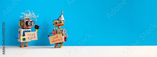 Job search concept. Two robots wants to get a job. Smiley unemployed robotic characters with a cardboard sign and handwritten text Need a job and Job Wanted. Blue gray background, copy space for text photo