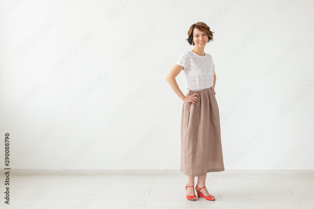 people, fashion and style concept - young woman posing in clothes in studio on white background. people, fashion and style concept - young woman posing in clothes in studio on white background.
