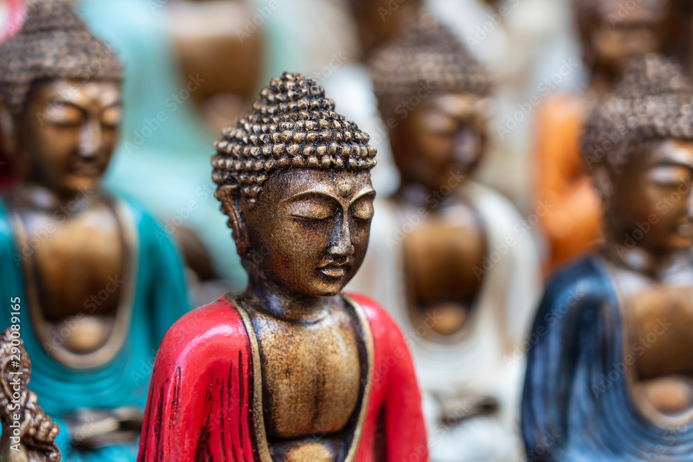 Buddha statue figures souvenir on display for sale on street market in Bali, Indonesia. Handicrafts and souvenir shop display, close up Buddha statue figures souvenir on display for sale on street market in Bali, Indonesia. Handicrafts and souvenir shop display, close up