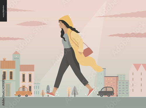 Rain - walking girl wearing raincoat -modern flat vector concept illustration of a young brunette woman in yellow waterproof, walking in the rain in the street, in front of city houses and cars.