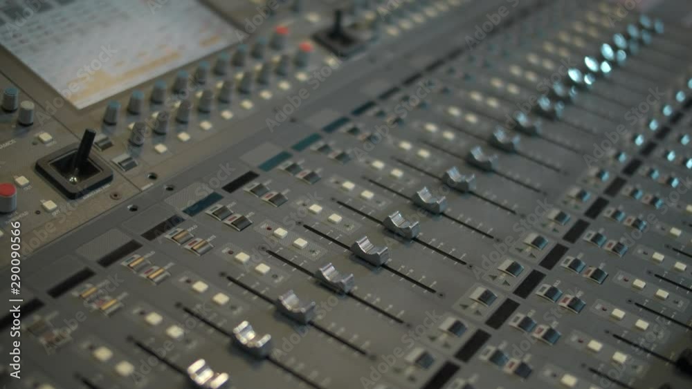 Close-up of a mixing console, automatic faders. Sound director works in the studio. Professional recording studio. Recording concept. Close-up of a mixing console, automatic faders. Sound director works in the studio. Professional recording studio. Recording concept.