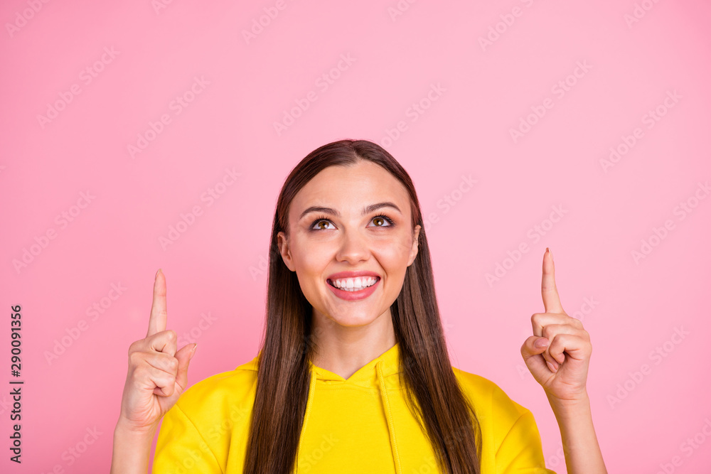 Close up photo of beautiful attractive charming sweet girlfriend wearing yellow sweater pointing up to sales indicated above while isolated over pink color pastel background Close up photo of beautiful attractive charming sweet girlfriend wearing yellow sweater pointing up to sales indicated above while isolated over pink color pastel background