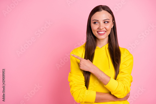 Copyspace photo of attractive cute pretty sweet nice charming girlfriend pointing away at emptiness to be fulfilled while isolated over pink pastel color background wearing yellow vivid sweater