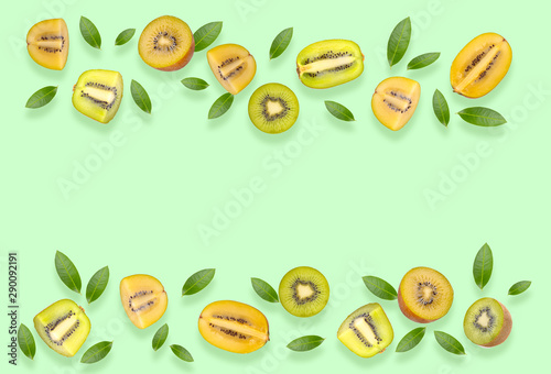 Fototapeta Naklejka Na Ścianę i Meble -  fresh green and yellow kiwi fruit top view on green background