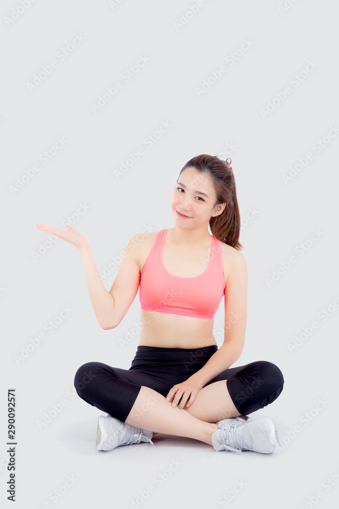 Beautiful portrait young asian woman in sport clothes with satisfied and confident presenting and show something isolated on white background, asia girl sitting exercise for fit with health concept. Beautiful portrait young asian woman in sport clothes with satisfied and confident presenting and show something isolated on white background, asia girl sitting exercise for fit with health concept.