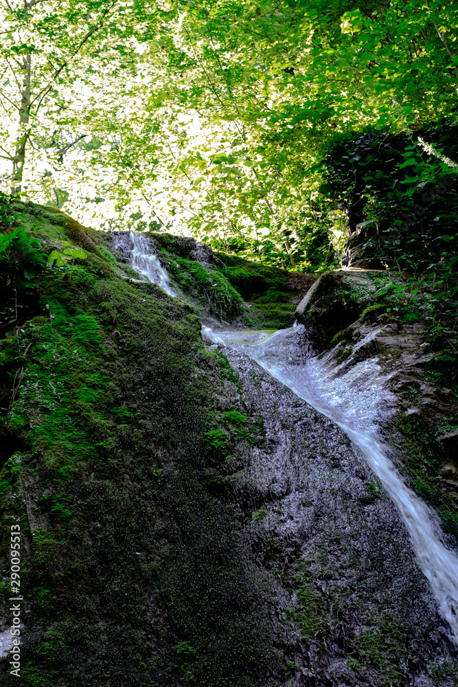 Waterfall from ravine.waterfall from the mountain river. rapid current Waterfall from ravine.waterfall from the mountain river. rapid current