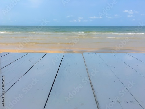 White wooden table with the sea background