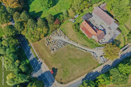 Vertical aerial view of a former farm  which is used as a warehouse for building materials.