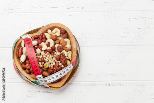 Various nuts selection on wooden table photo