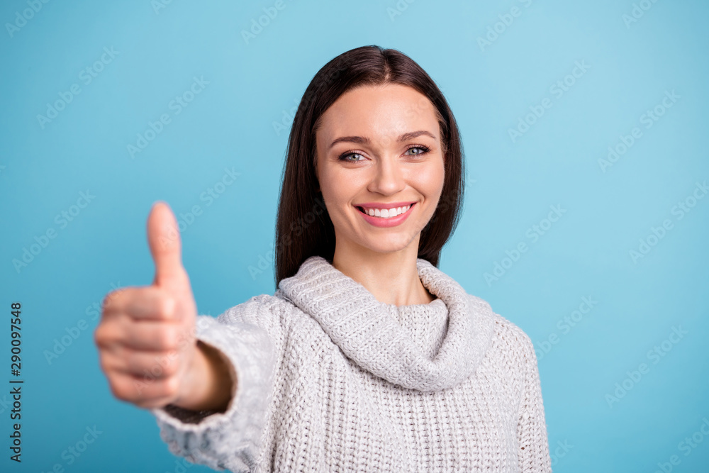 Close up photo of positive cheerful promoter recommend sales discount approve ads show thumbs-up wear white sweater isolated over blue color background Close up photo of positive cheerful promoter recommend sales discount approve ads show thumbs-up wear white sweater isolated over blue color background