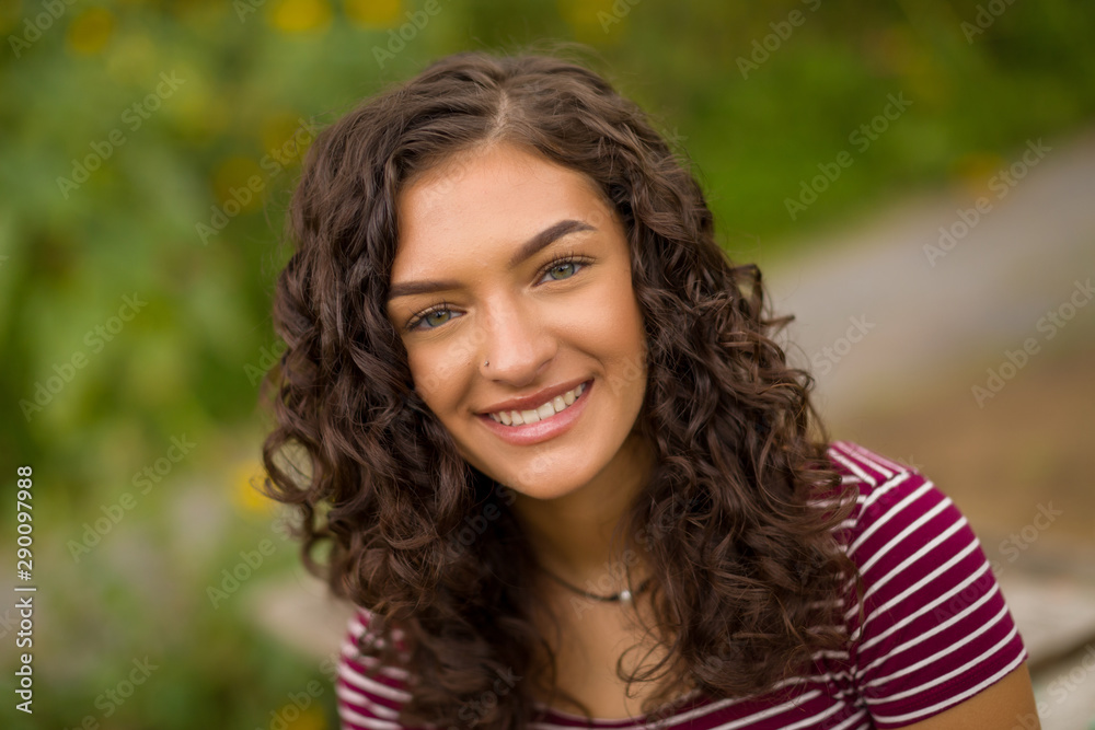 Happy teenage high school senior girl in sunflower field Happy teenage high school senior girl in sunflower field
