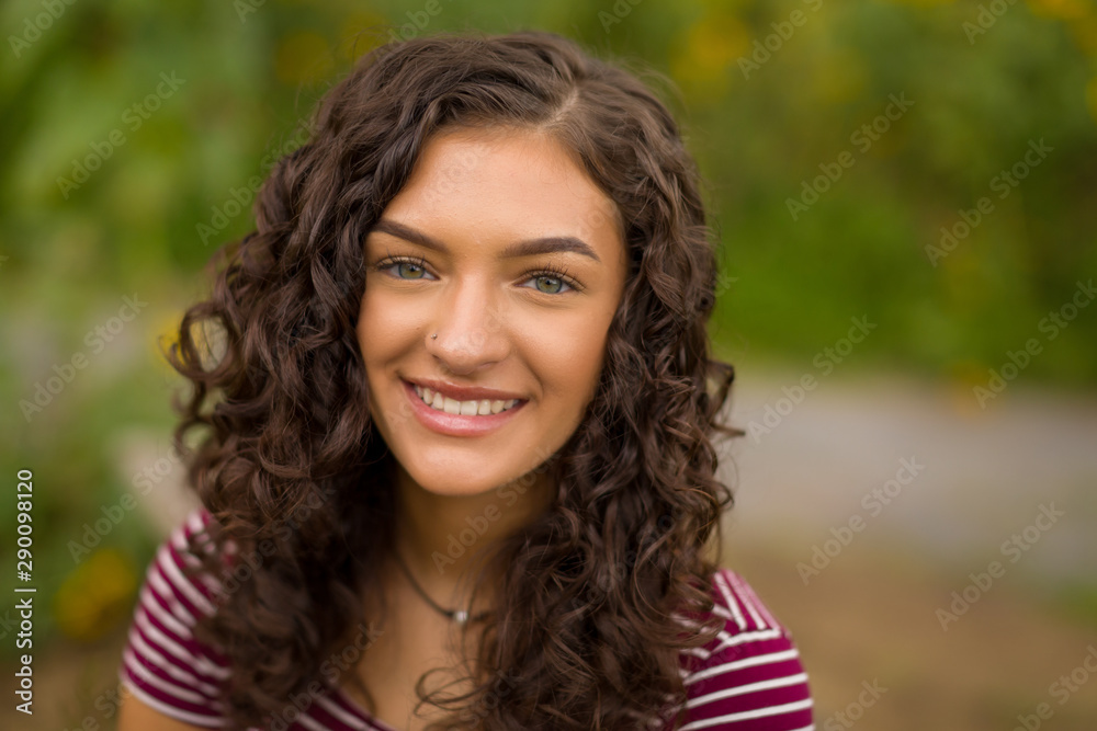 Happy teenage high school senior girl in sunflower field Happy teenage high school senior girl in sunflower field