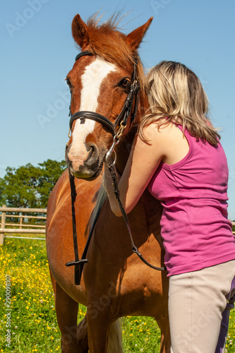 Portrait of a young girl and her pony having a hug, either in joy or sadness, no-one knows.