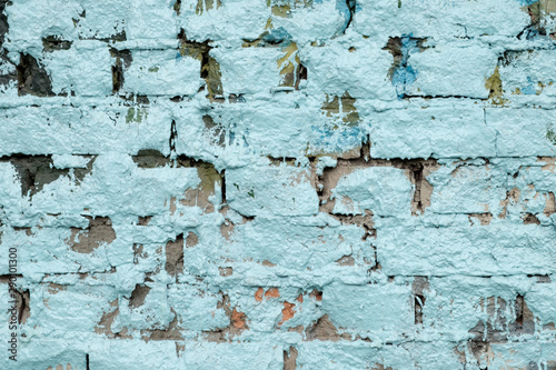 Wall of brick painted with blue paint, tecture, close-up