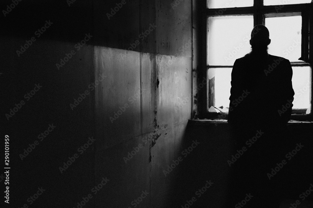 silhouette of a man in the window