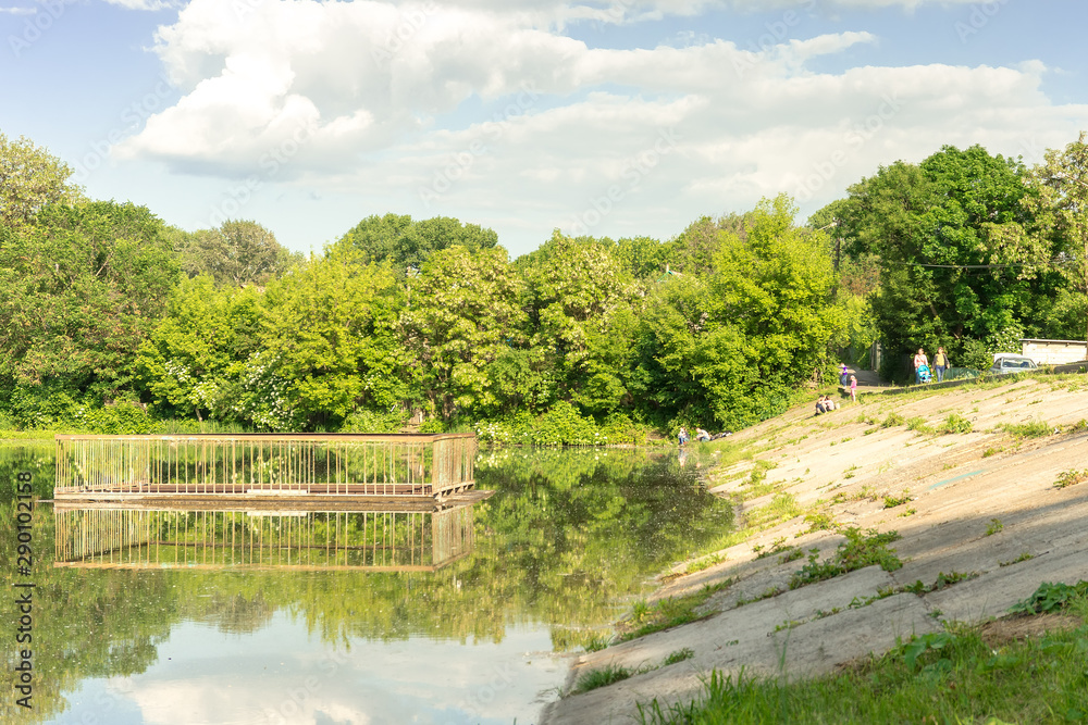 lake with a dam and a lock in the forest