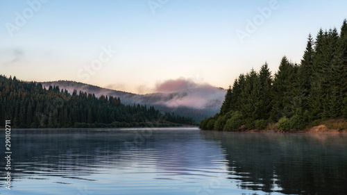 Misty mountain lake after sunrise 
