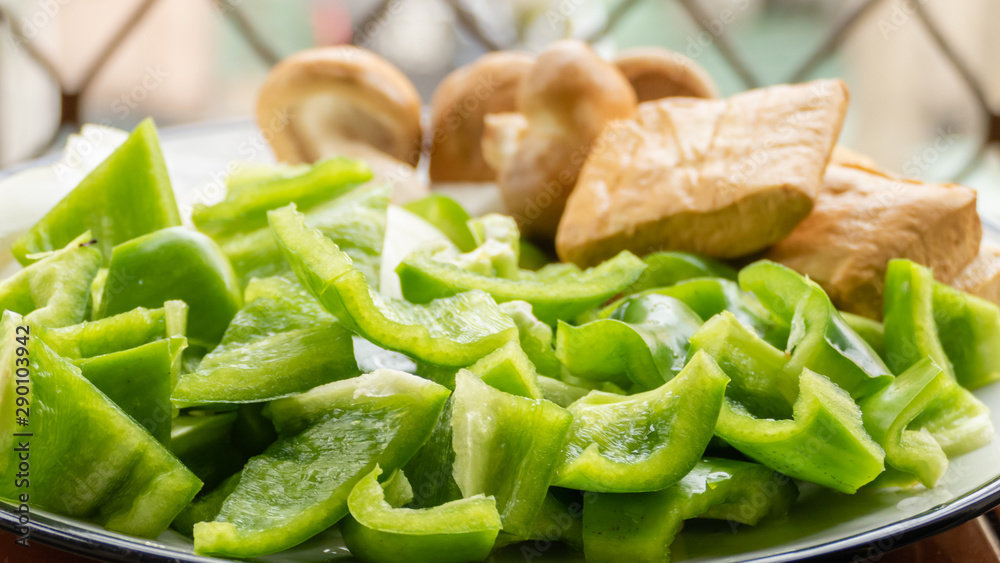 Green peppers, tofu, onion, and mushrooms in plate Green peppers, tofu, onion, and mushrooms in plate