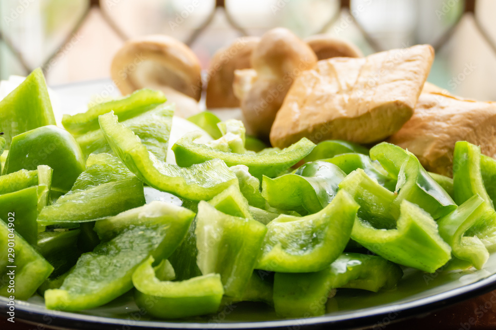 Green peppers, tofu, onion, and mushrooms in plate Green peppers, tofu, onion, and mushrooms in plate
