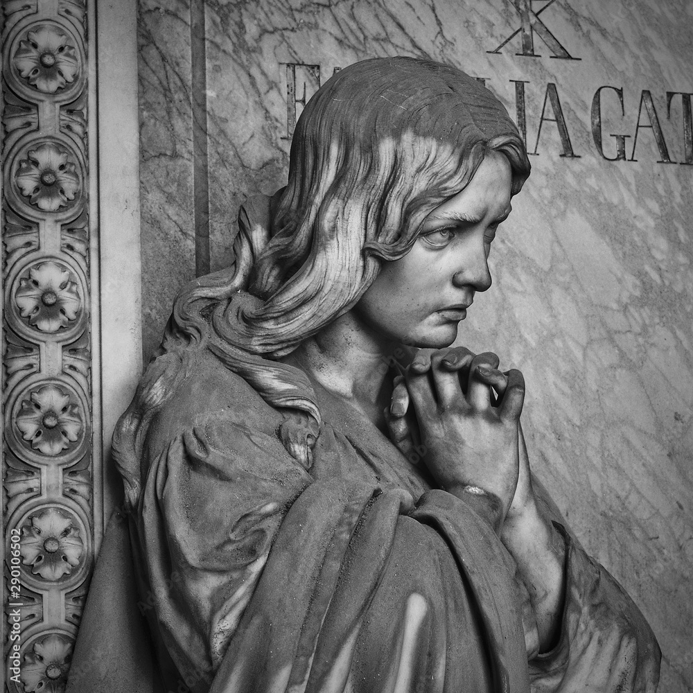 Young beautiful woman praying with hands clasped