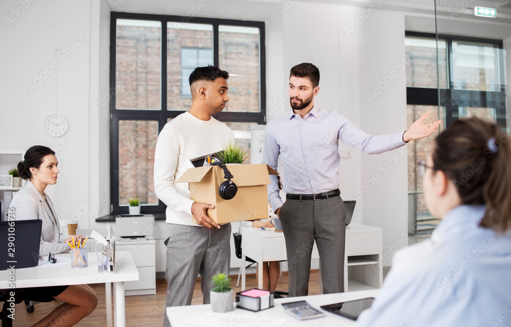 business, firing and job loss concept - executive seeing off sad fired male office worker holding box of his personal stuff business, firing and job loss concept - executive seeing off sad fired male office worker holding box of his personal stuff