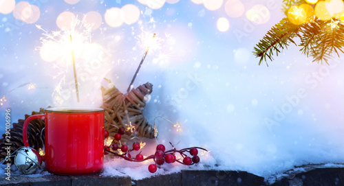 Art winter hot drink and Christmas tree Light on snow background;