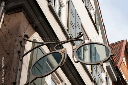bird control spikes at shop sign of an optician