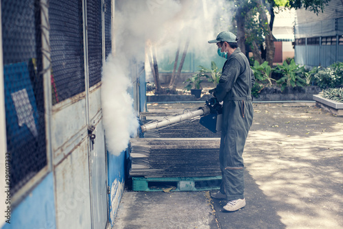 Soft focus man work fogging to eliminate mosquito for preventing spread dengue fever and zika virus
