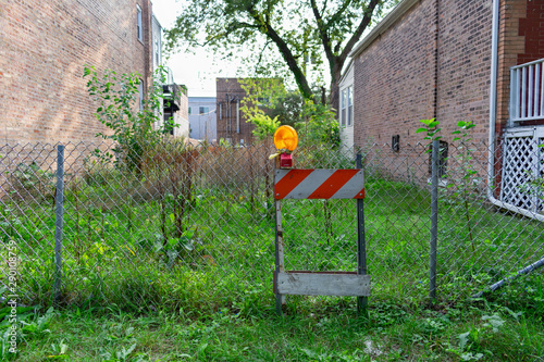 Photography Vacant Residential Lot with a Fence and Construction Barrier in Andersonville Ch