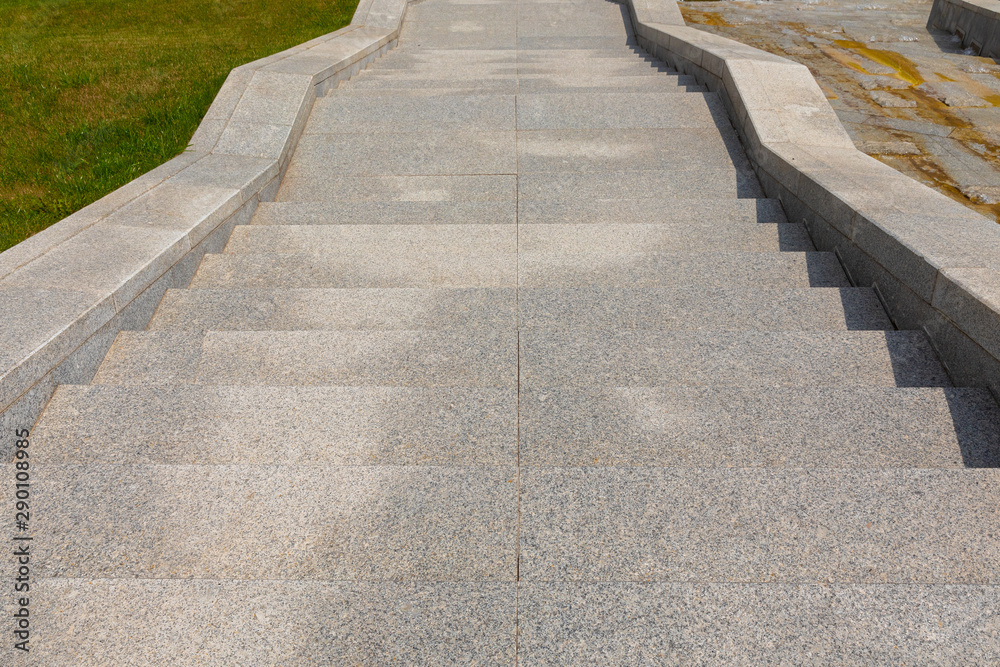 Obraz premium Granite tiled stone stairway leading down the street