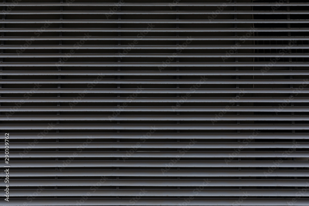 Gray galvanized thin layers of metal panels, horizontal pattern on gate door Gray galvanized thin layers of metal panels, horizontal pattern on gate door