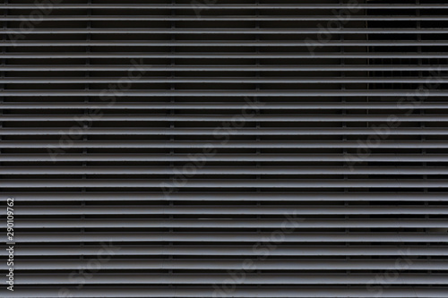 Gray galvanized thin layers of metal panels  horizontal pattern on gate door