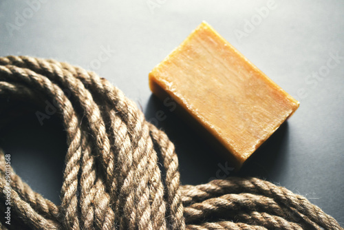 Rope and soap on a dark surface. Depiction of despair, suicide, death. photo