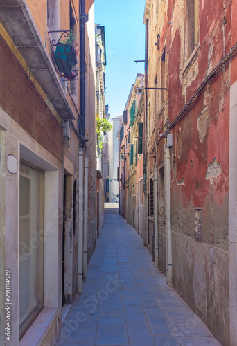 Narrow street with historic houses in Venice  Italy  in a beautiful sunny day.