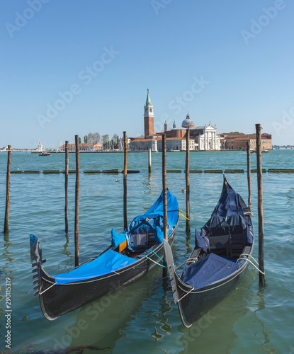 Gondolas near Saint Mark square  San Marco  and San Giorgio di Maggiore church in the background  in Venice  Italy