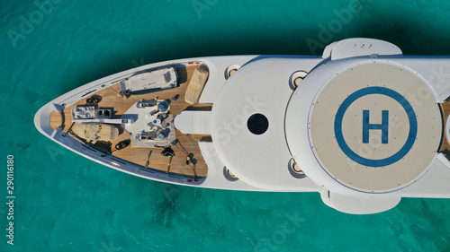 Aerial drone top down photo of luxury yacht docked in tropical exotic destination port with turquoise opean ocean sea © aerial-drone