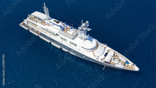 Aerial drone top down photo of luxury yacht with wooden deck cruising the Aegean deep blue sea © aerial-drone