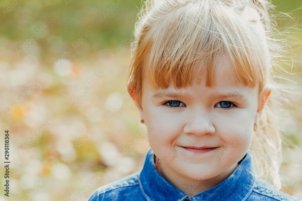 Little beautiful girl smiles and walks in the autumn park. Little beautiful girl smiles and walks in the autumn park.