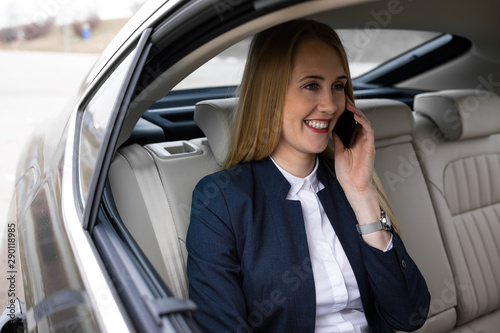 Beautiful attractive business woman is traveling to work in the car
