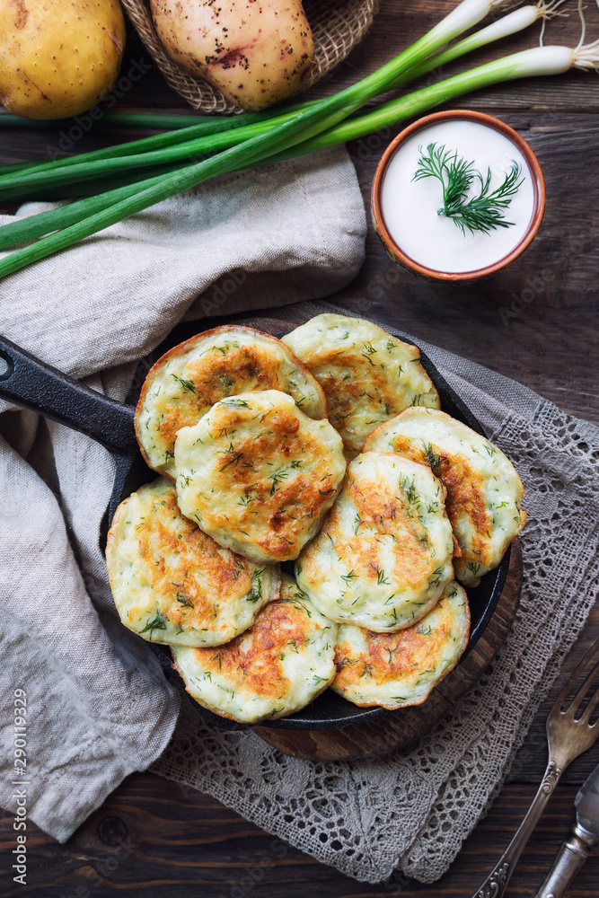Potato pancakes with dill in iron skillet