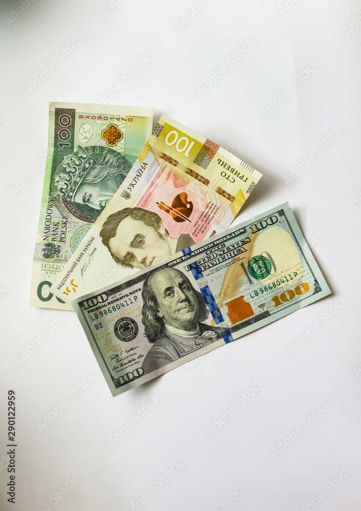 one hundred dollars one hundred hryvnia and one hundred zlotys on a white background one hundred dollars one hundred hryvnia and one hundred zlotys on a white background