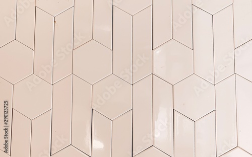 real photo of glossy white hexagonal tiles wall of the bathroom. geometric pattern  abstraction