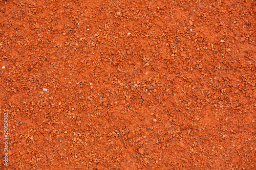 Red clay court tennis background texture. Tennis court close-up of gravel surface.