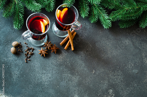 Christmas mulled red wine with spices on dark concrete background