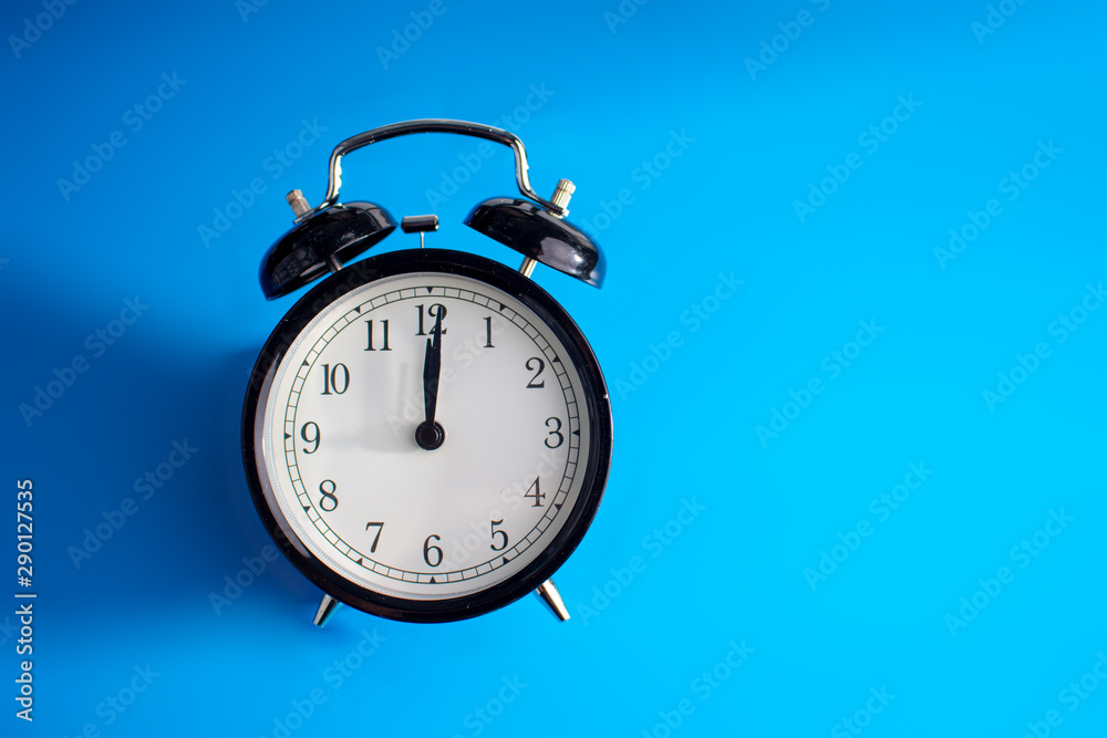 Clock on a blue background with a shadow on the left