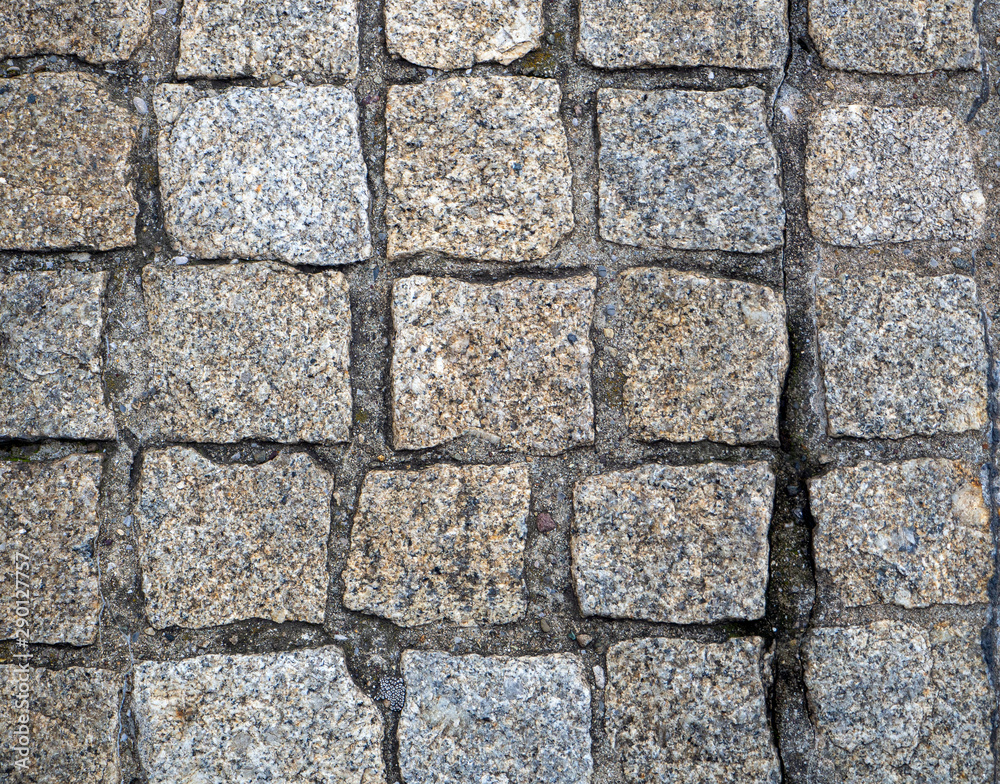 Stone pavers are lined with cobblestones of the same type Stone pavers are lined with cobblestones of the same type