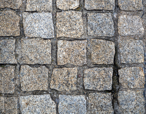 Stone pavers are lined with cobblestones of the same type