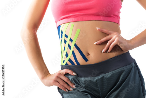Kinesiо medical tapes on the belly of a young woman