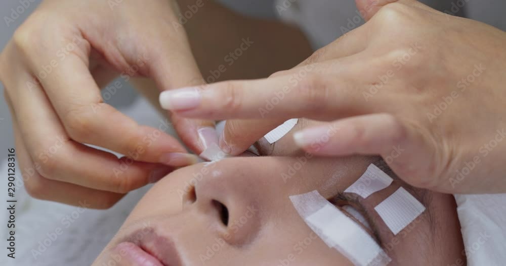 Woman having eyelash extension in beauty salon Woman having eyelash extension in beauty salon