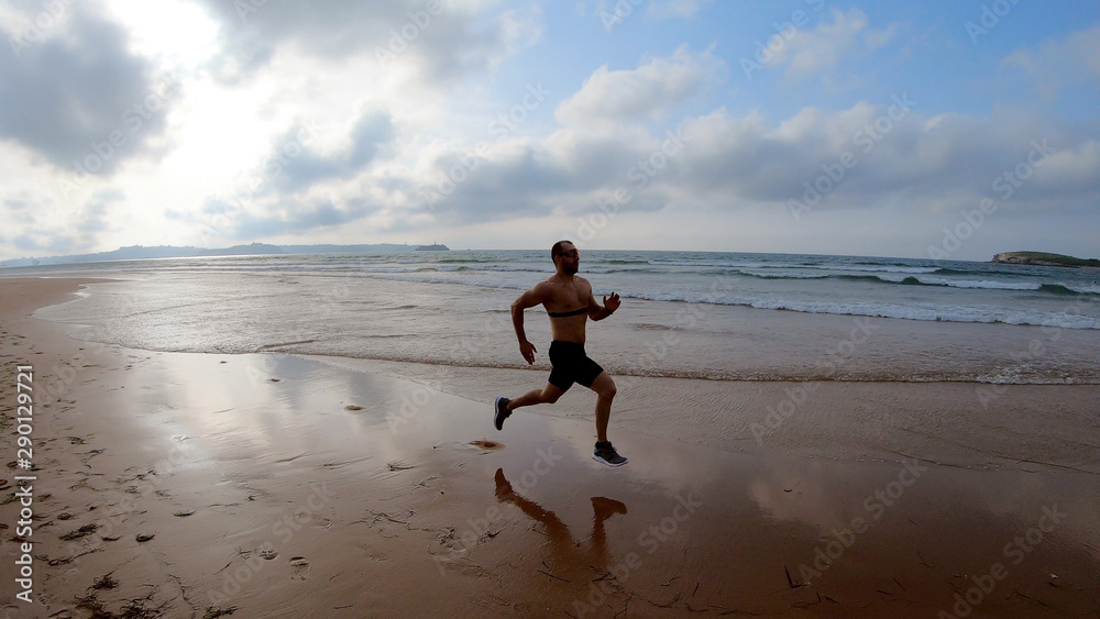 Athlete silhouette of runner running on beach Athlete silhouette of runner running on beach